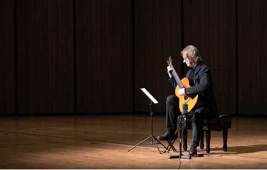 Classical guitarist performing on stage
