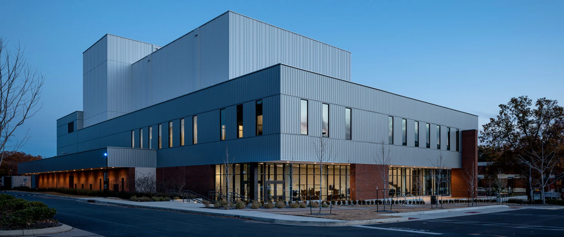 Exterior of the Scheidt Family Performing Arts Center at dusk.